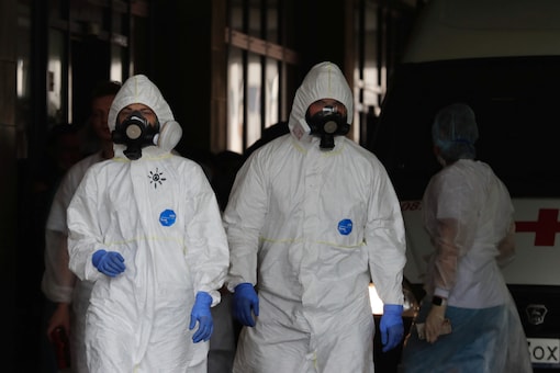 Medical specialists wearing personal protective equipment (PPE) walk outside outside the I.I. Dzhanelidze Research Institute of Emergency Medicine amid the outbreak of the coronavirus disease (COVID-19). 