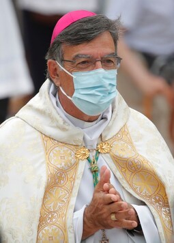 Wearing masks, French pilgrims send a message of hope ahead of religious feast