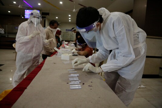 People stand in a queue to give their nasal swab samples to test for Covid-19 at a state transport bus station in Ahmedabad, on August 29, 2020. (AP Photo/Ajit Solanki)