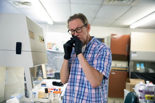 Genome scientist Preston Estep administers the eighth iteration of a peptide vaccine to himself, in Massachusetts, Aug. 20, 2020. (Kayana Szymczak/The New York Times)