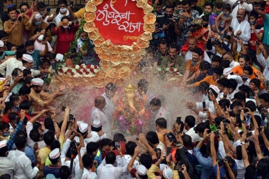 Volunteers immerse a clay idol of Ganesh in an artificial tank in Mumbai on Tuesday. (AFP)
