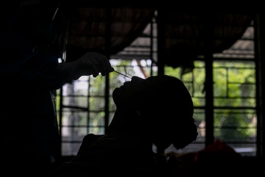 A health worker takes a nasal swab sample of a teacher to test for Covid-19 at a school in Gauhati, on September 2, 2020. (AP Photo/Anupam Nath)