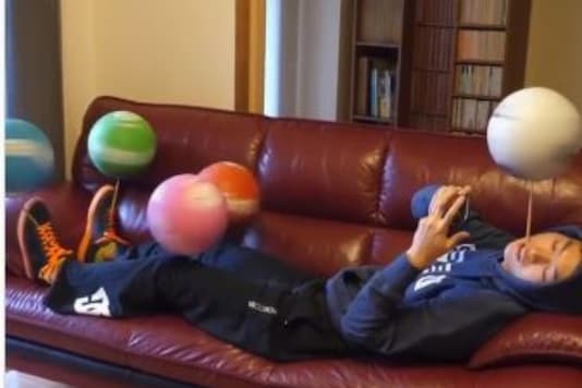 Screenshot of the video showing the man spinning five footballs at a time.