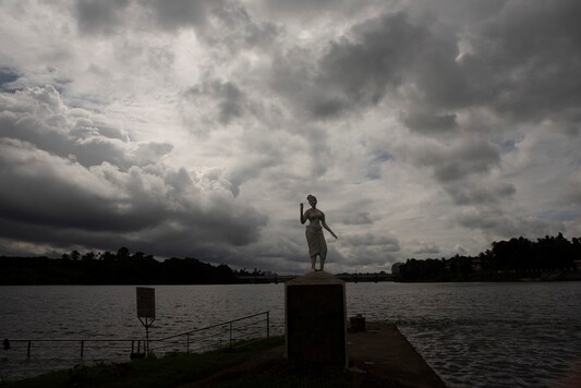 Rain clouds are seen behind a statue on the banks of the Periyar river in Kochi, Kerala state, India, Sunday, Sept.6, 2020. India's monsoon season runs from June to September. (AP Photo/R S Iyer)