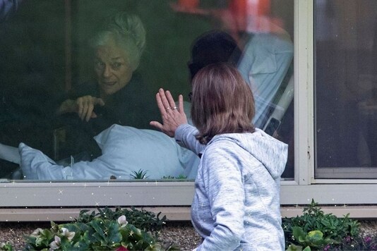 A woman visits her mother, 81, who tested positive for coronavirus at Life Care Center of Kirkland, the Seattle-area nursing home at the epicenter of one of the biggest coronavirus outbreaks in the United States. The pandemic, and the subsequent lockdowns imposed around the world left thousands of people longing for physical touch, for a hug, for love and for some semblance of what life used to be. (Credit: Reuters)