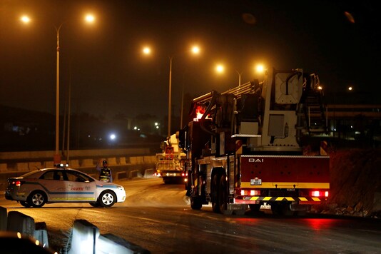 Civil defense vehicles leave for Amman after large explosions at a Jordanian army base outside Zarqa on the northeastern edge of Amman in Jordan. (Credit: REUTERS)