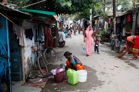 A woman washes clothes outside her house at a slum in New Delhi. (Image: Reuters/File)