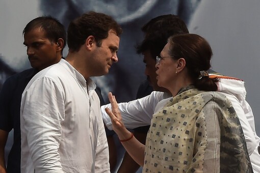 File photo: Congress chief Sonia Gandhi speaks with son and party leader Rahul Gandhi at an event to mark the 150th birth anniversary of Mahatma Gandhi in New Delhi, on October 2, 2019. (Photo by Money SHARMA / AFP)