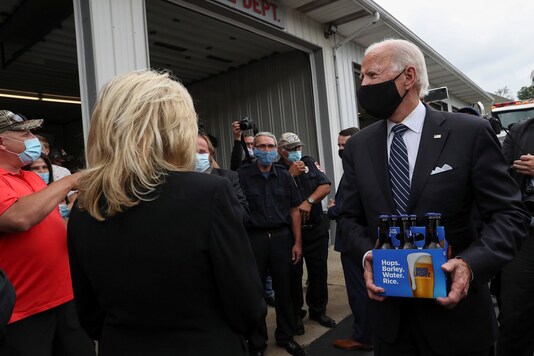 Democratic US presidential nominee Joe Biden carries a six pack of beer that he said he brought for firefighters after promising to bring beer during a previous visit to Shanksville fire station. Biden stopped at the fire hall after visiting the nearby Flight 93 National Memorial. (Credit: REUTERS) 