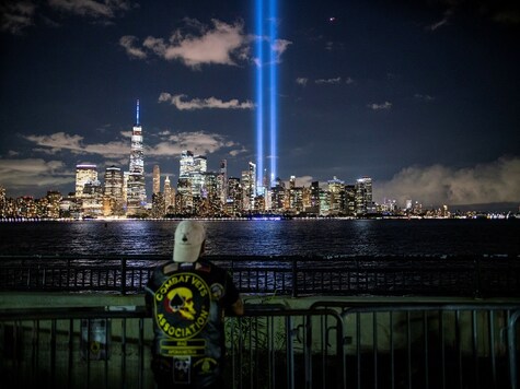 A man looks at The Tribute in Light installation from Liberty State Park, marking the 19th anniversary of the 9/11 attacks in New York City, as seen from Jersey City, New Jersey, U.S., September 11, 2020.  REUTERS/Eduardo Munoz