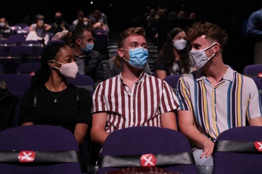 Theatregoers sit keeping a social distance as a precaution against the transmission of the novel coronavirus ahead of the start of Sleepless the Musical at the Troubadour Wembley Park Theatre in London on September 10, 2020. (AFP)

