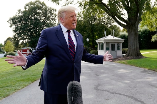 US President Donald Trump speaks with reporters as he walks to Marine One on the South Lawn of the White House. (AP Photo/Alex Brandon)