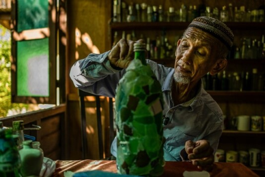 A 74-year-old Malaysian's quest to rid the country's beaches of washed-up glass led him to amassing a collection of thousands of bottles, now displayed in a colourful seaside museum. Mohd RASFAN - AFP
