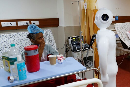 A patient suffering from the coronavirus disease (COVID-19) speaks to his family members, using a robot named 'Mitra' at the Intensive Care Unit (ICU) of the Yatharth Super Speciality Hospital in Noida. (Reuters)