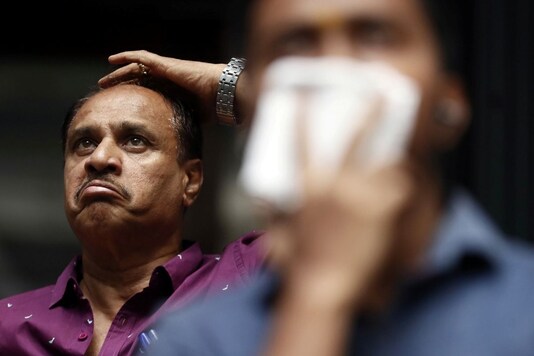A man reacts as he looks at a screen displaying the Sensex results on the facade of the Bombay Stock Exchange (BSE) building in Mumbai. (File photo/Reuters)
