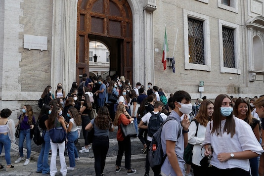 Students gather outside the Visconti high school on the first day of the reopening in Rome. (AP Photo/Gregorio Borgia) Students gather outside the Visconti high school on the first day of the reopening in Rome. (AP Photo/Gregorio Borgia)