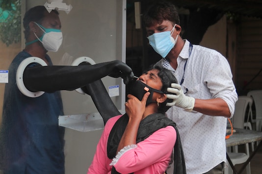Health workers collect a nasal swab sample to test for Covid-19 in Hyderabad, on September 17, 2020. (AP Photo/Mahesh Kumar A.)