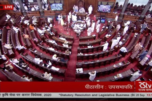 Opposition MPs protest in the well of the Rajya Sabha against the farm bills. (Twitter/@ANI)