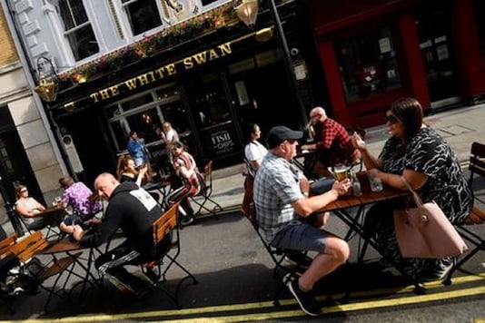File photo of people drink outside a pub at the Covent Garden shopping and dining district, amid the spread of the coronavirus disease (COVID-19), in London. (Reuters) File photo of people drink outside a pub at the Covent Garden shopping and dining district, amid the spread of the coronavirus disease (COVID-19), in London. (Reuters)