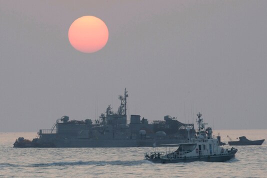 FILE - In this Dec. 22, 2010, file photo, a government ship sails past the South Korean Navy's floating base as the sun rises near Yeonpyeong island, South Korea. (AP Photo/Ahn Young-joon, File)