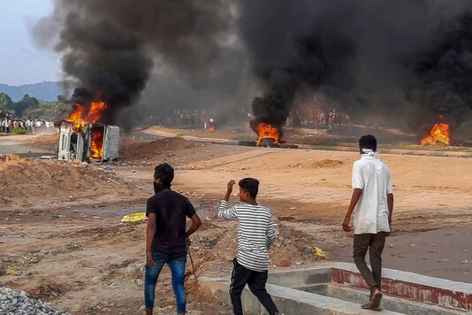 Vehicles and tires are torched during a protest demanding recruitment of reserved category candidates on vacant unreserved positions for teachers, in Kakari Dungri village of Rajasthan’s Dungarpur district, on September 25, 2020. (PTI Photo)