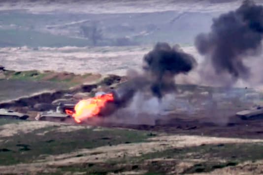 In this image taken from a footage released by Armenian Defense Ministry on September 27, 2020, Armenian forces destroy Azerbaijani military vehicle at the contact line of the self-proclaimed Republic of Nagorno-Karabakh, Azerbaijan. (Armenian Defense Ministry via AP)