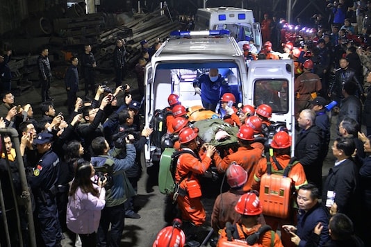 Rescue workers transfer a survivor to an ambulance at the Shanmushu coal mine owned by Sichuan Coal Industry Group, following a flooding accident at the mine on Saturday, in Yibin, Sichuan province, China December 18, 2019. China Daily via REUTERS Rescue workers transfer a survivor to an ambulance at the Shanmushu coal mine owned by Sichuan Coal Industry Group, following a flooding accident at the mine on Saturday, in Yibin, Sichuan province, China December 18, 2019. China Daily via REUTERS