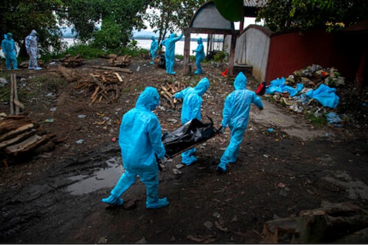 Health workers wearing personal protective equipment carry the body of a COVID-19 victim for cremation in Gauhati, India, Thursday, Sept. 10, 2020. (AP Photo/Anupam Nath) Health workers wearing personal protective equipment carry the body of a COVID-19 victim for cremation in Gauhati, India, Thursday, Sept. 10, 2020. (AP Photo/Anupam Nath)