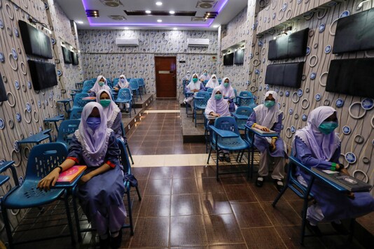 Students keep safe distance while attending an audio-visual class, as schools reopen amid the coronavirus disease (COVID-19) pandemic, in Karachi, Pakistan September 15, 2020. REUTERS/Akhtar Soomro