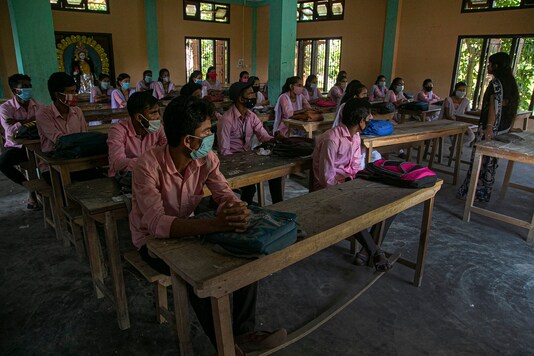 Indian students sit wearing masks after classes started at a college in Jhargaon village, outskirts of Gauhati, India, Wednesday, September 30, 2020. (Image: AP)