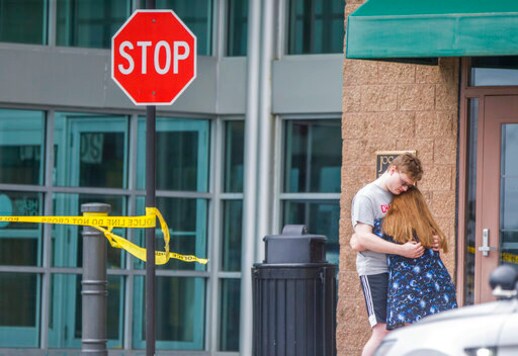 People hug after being evacuated from University Park Mall following a shooting on Saturday, Sept. 12, 2020, in Mishawaka, Ind. A shooting at the northern Indiana mall left one person dead and sent shoppers running for safety, authorities said. St. Joseph County Coroner Michael McGann said Saturday evening that one person was killed in the shooting about 3 p.m. at the mall. (Robert Franklin/South Bend Tribune via AP)