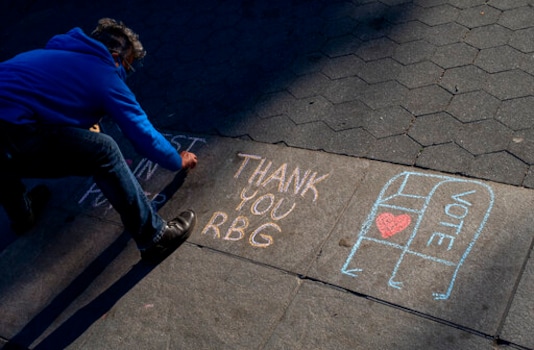 Kimberly Miller, of the Brooklyn borough of New York, who is with Gays Against Guns, leaves a chalk message honoring Justice Ruth Bader Ginsburg on a Washington Square Park walkway in New York Saturday, Sept. 19, 2020, a day after the death of the Supreme Court justice. (AP Photo/Craig Ruttle) Kimberly Miller, of the Brooklyn borough of New York, who is with Gays Against Guns, leaves a chalk message honoring Justice Ruth Bader Ginsburg on a Washington Square Park walkway in New York Saturday, Sept. 19, 2020, a day after the death of the Supreme Court justice. (AP Photo/Craig Ruttle)