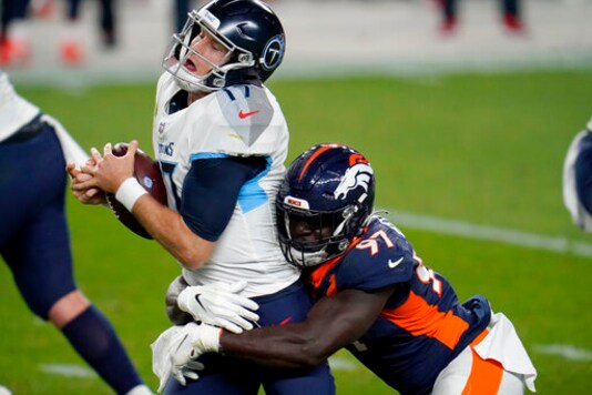 Tennessee Titans quarterback Ryan Tannehill (17) is sacked by Denver Broncos linebacker Jeremiah Attaochu (97) during the first half of an NFL football game, Monday, Sept. 14, 2020, in Denver. (AP Photo/David Zalubowski)