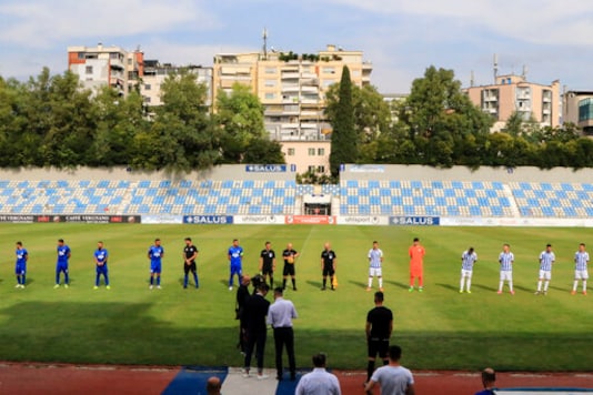 Players of Tirana, right, and Teuta Durres clubs stand on the pitch as they stage a protest at the Selman Stermasi stadium, in Tirana, on Saturday, Sept. 19, 2020. Albania's main soccer clubs continued the boycott of the new season for the second week calling on the government to fulfill their requests for more financial support. (AP Photo/Hektor Pustina)