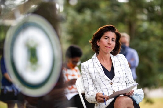 FILE - In this June 22 2020 file photo Rhode Island Gov. Gina Raimondo sits during a news conference in Providence, R.I.,   Raimondo, on Friday, Sept. 25,  blamed outbreaks at two colleges for a surge of virus cases that boosted the state's infection rate high enough to put it on the list of places whose residents are required to quarantine when traveling to New York, New Jersey and Connecticut. (AP Photo/David Goldman)
