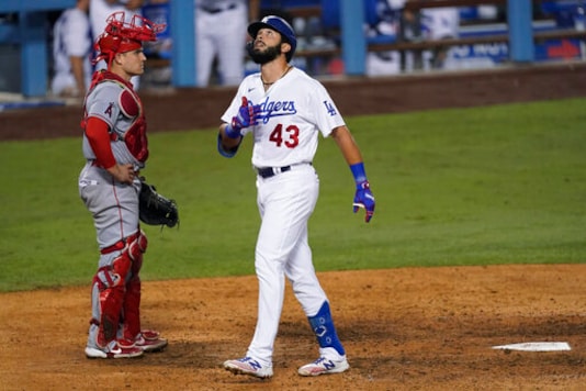 Los Angeles Dodgers' Edwin Rios looks up after scoring on a home run during the seventh inning of the team's baseball game against the Los Angeles Angels on Saturday, Sept. 26, 2020, in Los Angeles. (AP Photo/Ashley Landis) Los Angeles Dodgers' Edwin Rios looks up after scoring on a home run during the seventh inning of the team's baseball game against the Los Angeles Angels on Saturday, Sept. 26, 2020, in Los Angeles. (AP Photo/Ashley Landis)