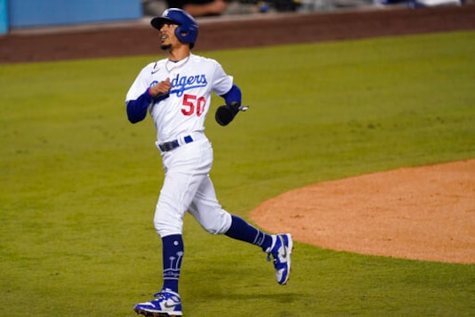 Los Angeles Dodgers' Mookie Betts turns to the dugout after scoring a double steal during the first inning of the team's baseball game against the Los Angeles Angels on Friday, Sept. 25, 2020, in Los Angeles. (AP Photo/Ashley Landis) Los Angeles Dodgers' Mookie Betts turns to the dugout after scoring a double steal during the first inning of the team's baseball game against the Los Angeles Angels on Friday, Sept. 25, 2020, in Los Angeles. (AP Photo/Ashley Landis)