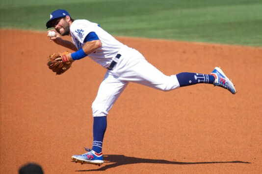 Los Angeles Dodgers second baseman Chris Taylor fields a ground ball during the second inning of a baseball game against the Los Angeles Angels in Los Angeles, Sunday, Sept. 27, 2020. (AP Photo/Kyusung Gong)