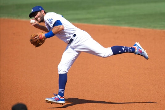 Los Angeles Dodgers second baseman Chris Taylor fields a ground ball during the second inning of a baseball game against the Los Angeles Angels in Los Angeles, Sunday, Sept. 27, 2020. (AP Photo/Kyusung Gong) Los Angeles Dodgers second baseman Chris Taylor fields a ground ball during the second inning of a baseball game against the Los Angeles Angels in Los Angeles, Sunday, Sept. 27, 2020. (AP Photo/Kyusung Gong)