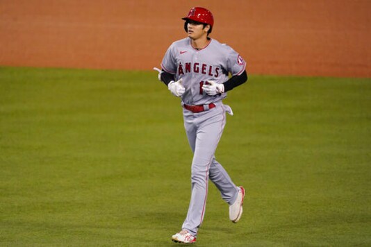 Los Angeles Angels designated hitter Shohei Ohtani returns to the dugout after hitting a fly ball to left field during the third inning of a baseball game against the Los Angeles Dodgers, Saturday, Sept. 26, 2020, in Los Angeles. (AP Photo/Ashley Landis)