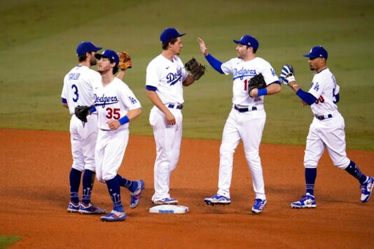 The Los Angeles Dodgers celebrate a 5-1 win over the Oakland Athletics in a baseball game Thursday, Sept. 24, 2020, in Los Angeles. (AP Photo/Marcio Jose Sanchez) The Los Angeles Dodgers celebrate a 5-1 win over the Oakland Athletics in a baseball game Thursday, Sept. 24, 2020, in Los Angeles. (AP Photo/Marcio Jose Sanchez)