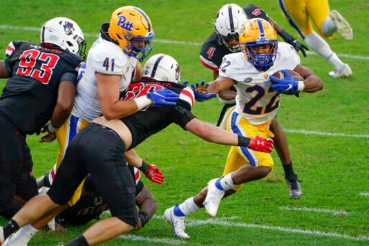 Pittsburgh running back Vincent Davis (22) evades Austin Peay linebacker Hunter Scholato (36) as he dashes for a touchdown during the second half of an NCAA college football game, Saturday, Sept. 12, 2020, in Pittsburgh. (AP Photo/Keith Srakocic) Pittsburgh running back Vincent Davis (22) evades Austin Peay linebacker Hunter Scholato (36) as he dashes for a touchdown during the second half of an NCAA college football game, Saturday, Sept. 12, 2020, in Pittsburgh. (AP Photo/Keith Srakocic)