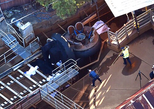 Emergency service personnel investigate at an accident scene at an amusement theme park on the Gold Coast, Australia, Oct. 25, 2016. The company that owns the Australian theme park where four people died on a river rapids ride was fined 3.6 million Australian dollars ($2.5 million) on Monday, Sept. 28, 2020, for safety breaches that led to the 2016 tragedy. (Dan Peled/AAP Image via AP)