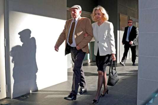 Don Spiers, left, and Carol Spiers, center, the parents of Sarah Spiers, arrive at the Supreme Court of Western Australia in Perth, Thursday, Sept. 24, 2020. A judge found a man guilty of murdering two women but not guilty of murdering a third in crimes that terrorised the Australian city of Perth in the late 1990s. Sarah Spiers, 18, Jane Rimmer, 23, and Ciara Glennon, 27, vanished after nights out with friends in the up-market Claremont nightlife precinct in 1996 and 1997. (Richard Wainwright/AAP Image via AP)
