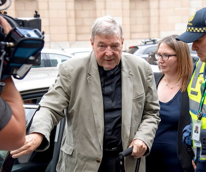 FILE - In this Feb. 26, 2019, file photo, Cardinal George Pell arrives at the County Court in Melbourne, Australia. Pell, Pope Francis' former finance minister, will soon return to the Vatican during an extraordinary economic scandal for the first time since he was cleared of child abuse allegations in Australia five months ago, a newspaper has reported, Monday, Sept. 28, 2020. (AP Photo/Andy Brownbill, File)