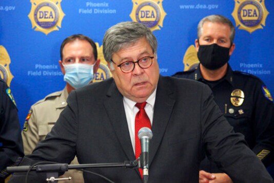 U.S. Attorney General William Barr speaks at a news conference, Thursday, Sept. 10, 2020, in Phoenix, where he announced results of a crackdown on international drug trafficking. Barr spent much of his time attacking mail-in voting, defending a Justice Department decision to take over defense of President Trump in a defamation case and discussing the civil unrest triggered by the killing of George Floyd by Minneapolis police in May. (AP Photo/Bob Christie)