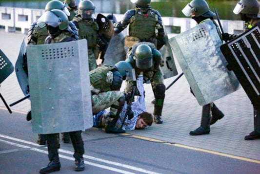 Riot police detain a protester during an opposition rally to protest the presidential inauguration in Minsk, Belarus, Wednesday, Sept. 23, 2020. Belarus President Alexander Lukashenko has been sworn in to his sixth term in office at an inaugural ceremony that was not announced in advance amid weeks of huge protests saying the authoritarian leader's reelection was rigged. Hundreds took to the streets in several cities in the evening to protest the inauguration. (AP Photo/TUT.by)