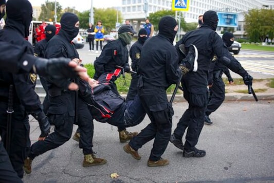 Police detain a demonstrator during an opposition rally to protest the official presidential election results in Minsk, Belarus, Sunday, Sept. 27, 2020.Hundreds of thousands of Belarusians have been protesting daily since the Aug. 9 presidential election. (AP Photo/TUT.by)