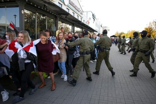 Police officers detain women during an opposition rally to protest the official presidential election results in Minsk, Belarus, Saturday, Sept. 19, 2020. Daily protests calling for the authoritarian president's resignation are now in their second month and opposition determination appears strong despite the detention of protest leaders. (AP Photo/TUT.by)