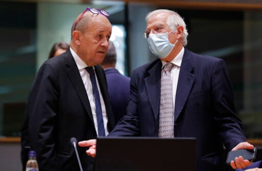 French Foreign Minister Jean-Yves Le Drian, left, speaks with European Union foreign policy chief Josep Borrell during a meeting of EU foreign affairs ministers at the European Council building in Brussels, Monday, Sept. 21, 2020. (Olivier Hoslet, Pool via AP)